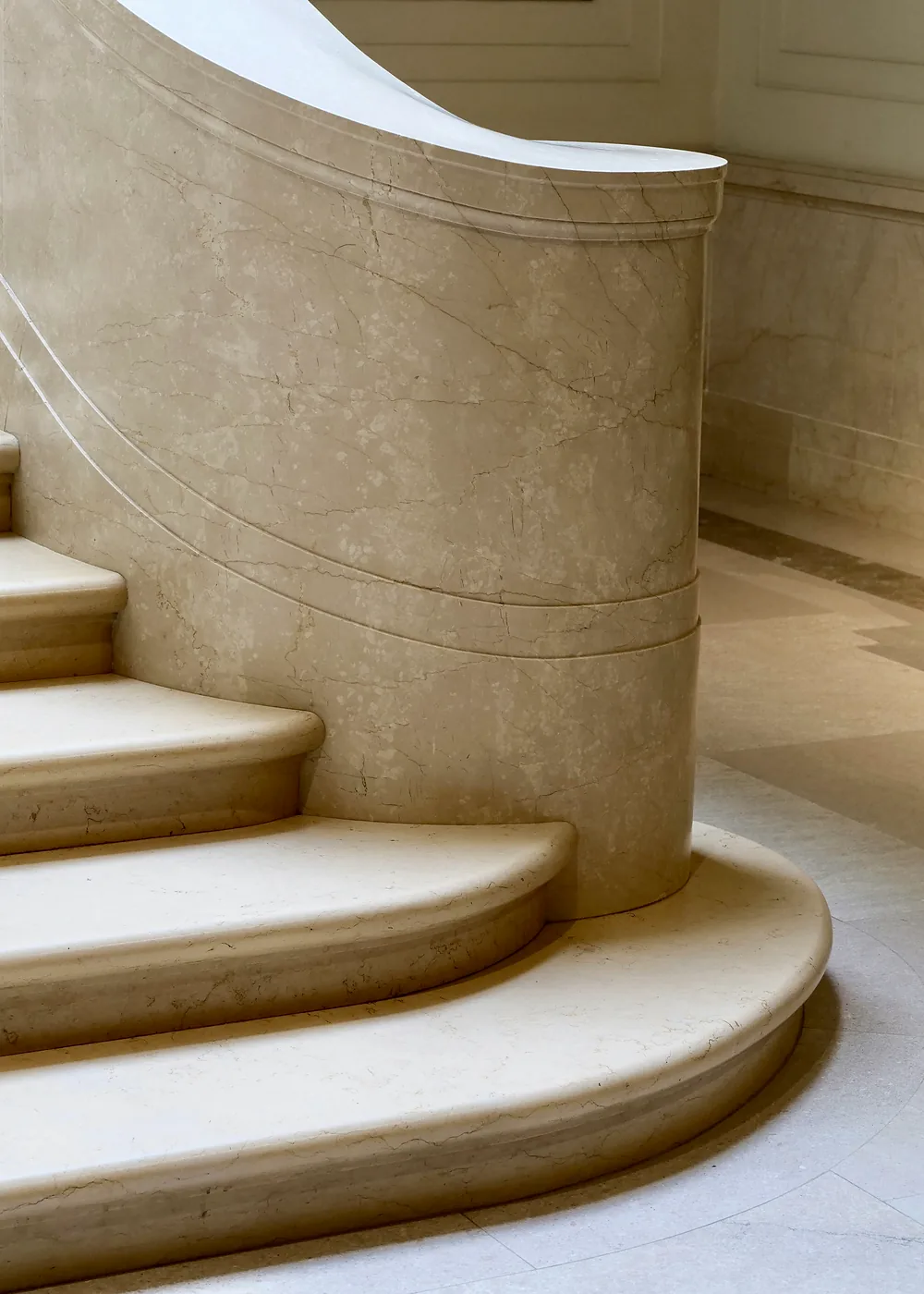 Curved marble staircase seen from below