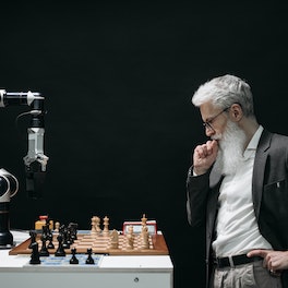 Elderly Man Thinking while Looking at a Chessboard